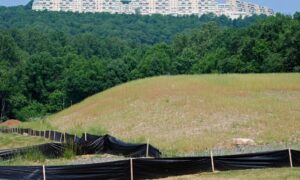 Sloped lot prepared for construction showing elevation changes and grading conditions