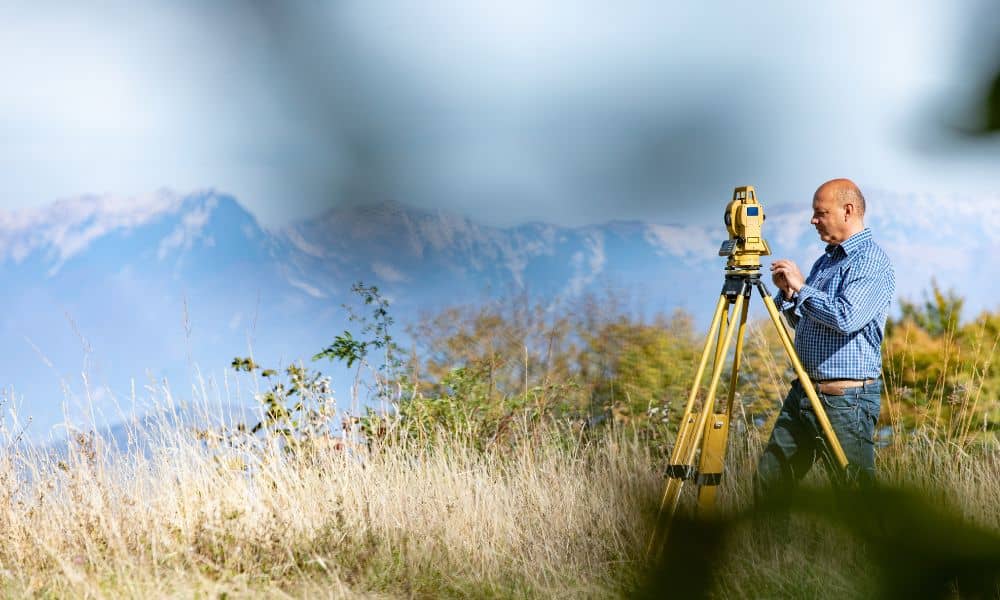 Alta land title survey boundary verification - ALTA SURVEY Utah Land surveyor using a total station to verify a property corner for an ALTA Land Title Survey in open terrain