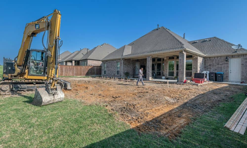 A backyard construction area close to a shared fence, showing how a property line survey helps prevent boundary mistakes and neighbor disputes