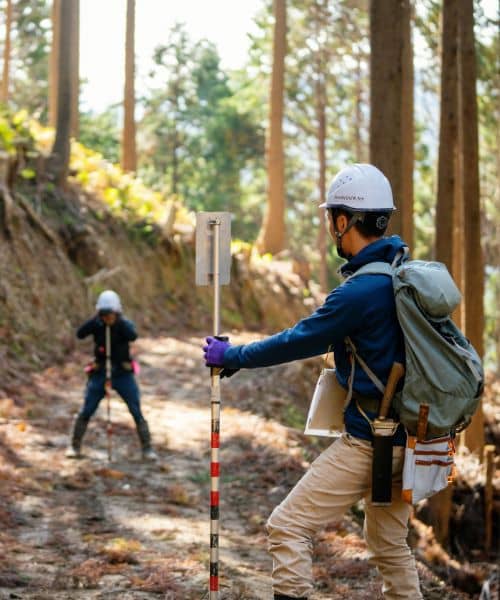 Field survey crew on site - ALTA SURVEY Utah Surveyors measuring land features in the field to support accurate ALTA Land Title Survey decisions after trust land reviews