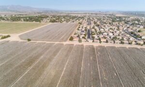 Aerial view of farmland being converted into a new housing subdivision, showing how rapid development increases the need for a subdivision survey