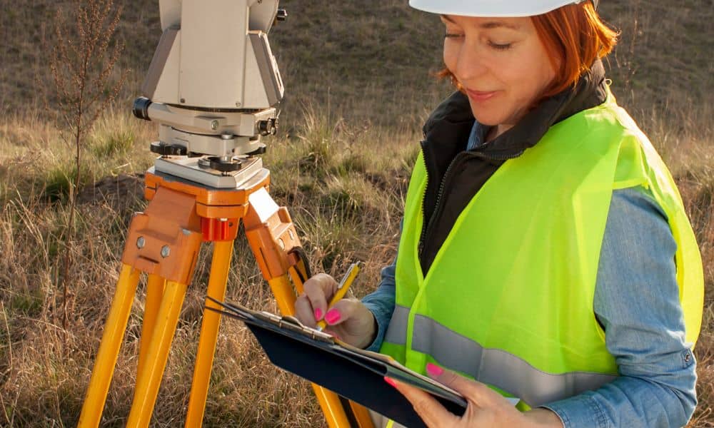 Surveyor reviewing property documents before site visit - ALTA SURVEY Utah Surveyor reviewing documents and site notes before conducting a title survey