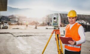Commercial land surveying job site - ALTA SURVEY Utah ALTA Surveyor using a total station on a commercial property before closing