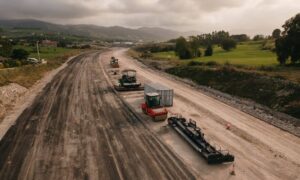 Freeway construction site with road grading and earthwork in progress showing large-scale infrastructure work monitored through a drone survey