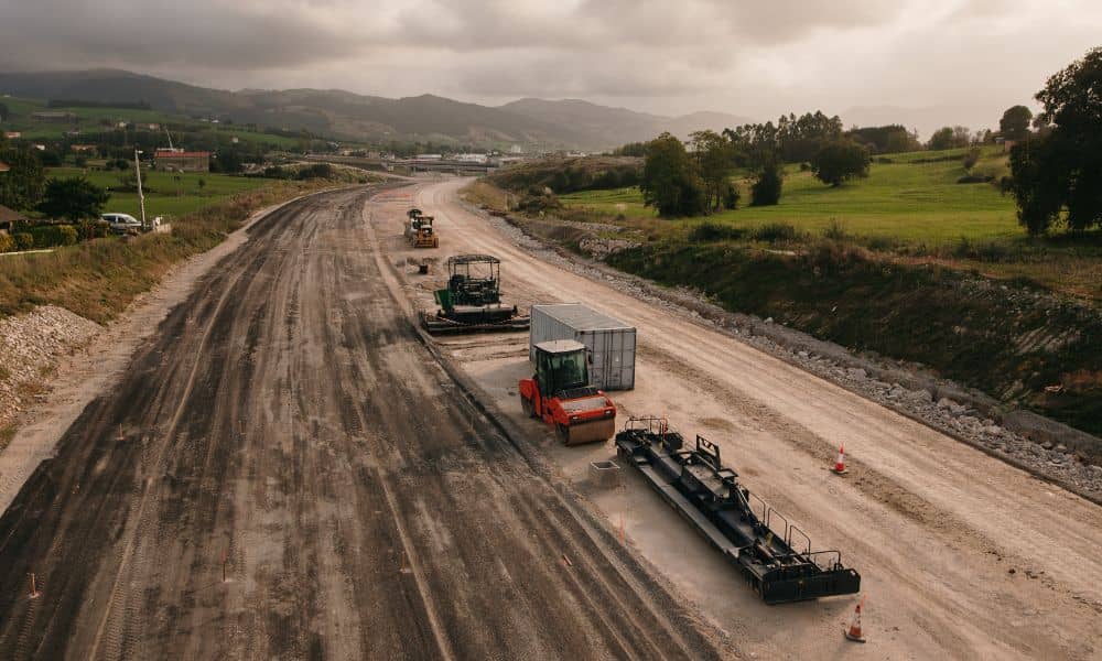 Freeway construction site with road grading and earthwork in progress showing large-scale infrastructure work monitored through a drone survey