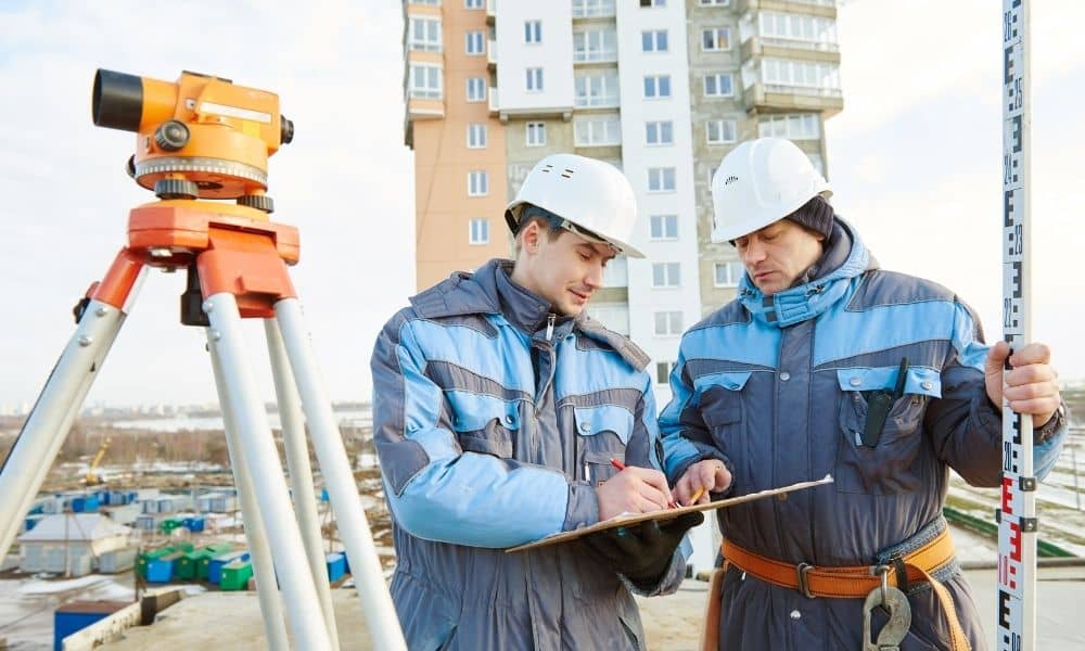 Survey crew performing an as-built survey and site verification at a completed commercial property